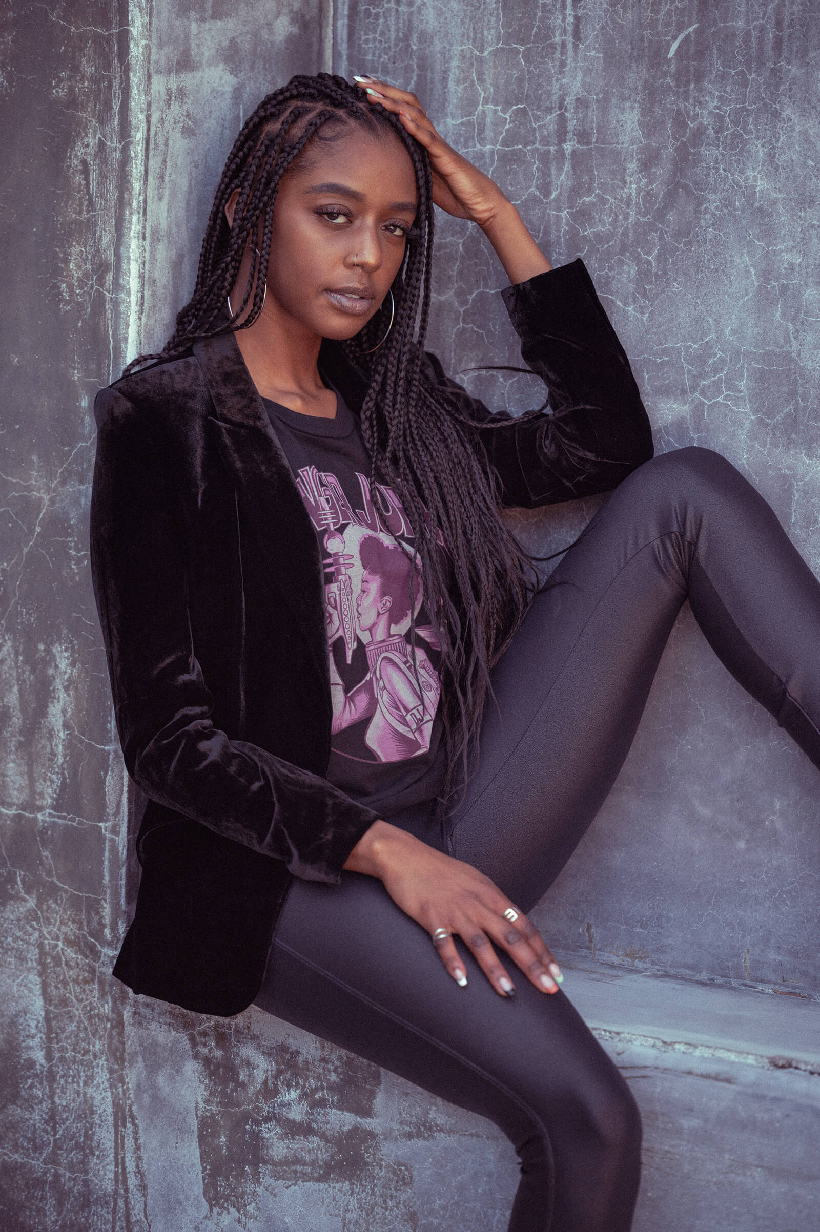 Model sitting wearing a Danger Jones Ray Gun Women's Tee Shirt and a black blazer.