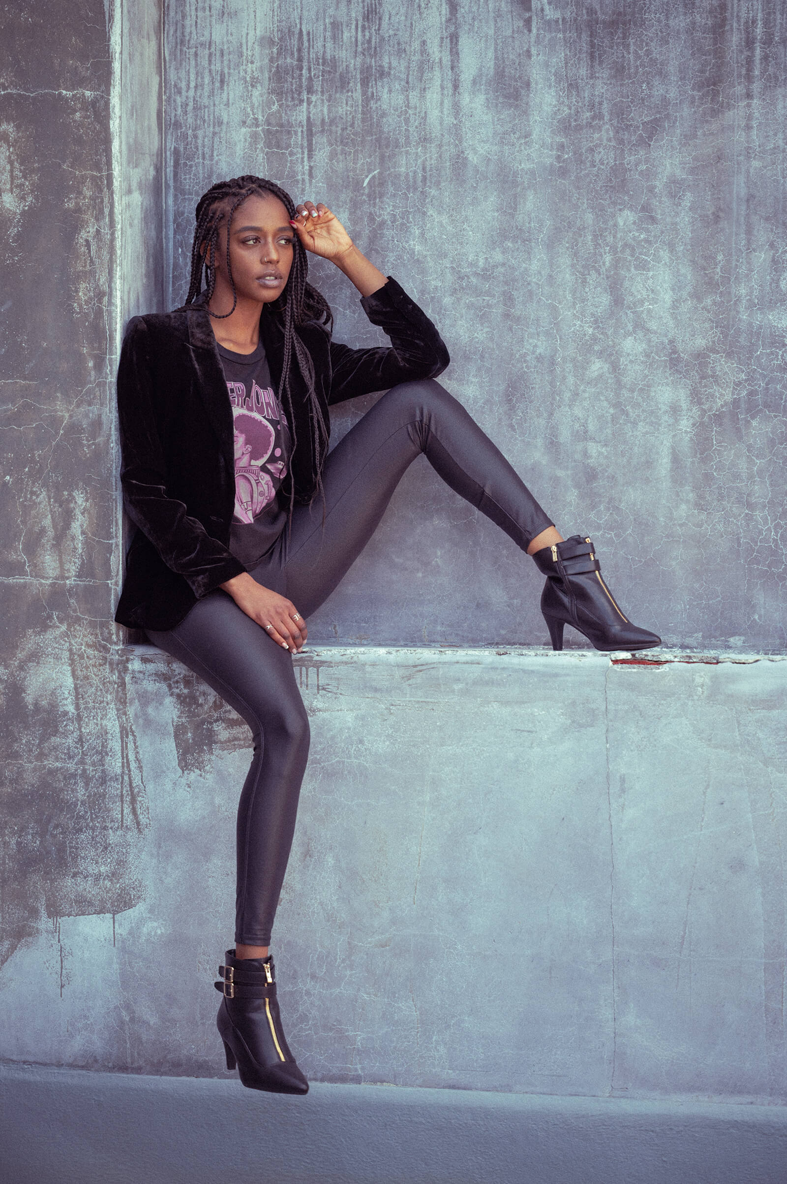 Model sitting wearing a Danger Jones Ray Gun Women's Tee Shirt and a black blazer.